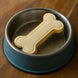 Bone-shaped cookie in a dog bowl on a wooden surface from a 5 inch Dog Bone Metal Cookie Cutter