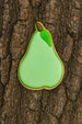 Green pear-shaped cookie on a tree trunk from a 3.25 inch Pear Metal Cookie Cutter