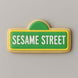 Cookie shaped like a Sesame Street sign with green background and white text on a gray background from a 5 inch Street Sign Metal Cookie Cutter