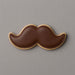 Cookie shaped like a mustache on a gray background from a 5 inch Mustache Metal Cookie Cutter
