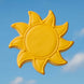 Yellow sun-shaped cookie against a blue sky from a 3.5 inch Sun Metal Cookie Cutter