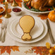 Thanksgiving table setting with a turkey-shaped cookie on a plate, surrounded by fall decorations from a 2 inch Mini Turkey Chicken Leg Drumstick Metal Cookie Cutter