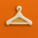 Cookie shaped like a hanger on an orange background from a  5 inch Clothes Hanger Metal Cookie Cutter
