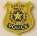 Yellow police badge with star and text on a beige background from a 3.5 inch Police Badge or Interstate Sign Metal Cookie Cutter