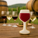 Wine glass-shaped cookie on a wooden table with wine glasses and barrels in the background from a 4 inch Wine Glass Metal Cookie Cutter