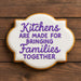 4.5 inch Plaque Metal Cookie Cutter shaped cookie with purple icing text showing "Kitchens Are Made For Bringing Families Together".