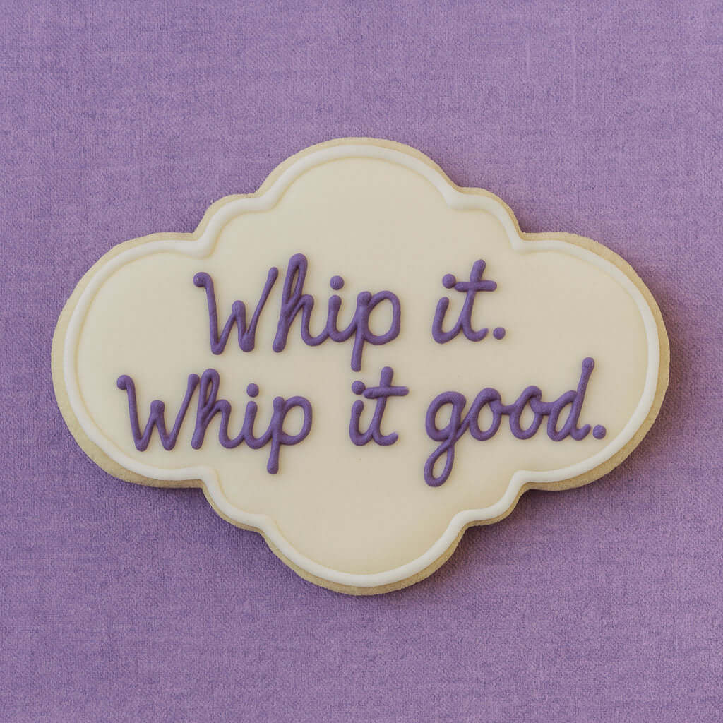 4.5 inch Plaque Metal Cookie Cutter shaped cookie decorated with purple icing saying 'Whip it. Whip it good.'