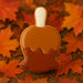 Cookie-shaped like a carmel apple on orange and red autumn leaves from a 4 inch Candy Carmel Apple Metal Cookie Cutter