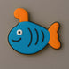Fish-shaped cookie with blue body, orange tail and fins on a gray background from a 4 inch Submarine Metal Cookie Cutter