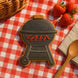 Cookie shaped like a barbecue grill on a red and white checkered tablecloth with strawberries and a wooden spoon from a 4.25 inch BBQ Grill Metal Cookie Cutter