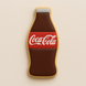 Cookie shaped like a Coca-Cola bottle on a beige background from a 5 inch Soda Pop Bottle Metal Cookie Cutter