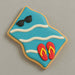 Cookie with blue background, sunglasses, and red flip-flops on a gray background from a 4 inch Beach Towel Blanket Metal Cookie Cutter