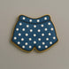 Cookie shaped like underwear with blue polka dot pattern on a beige background from a 3.5 inch Shorts or Swim Trunks Metal Cookie Cutter
