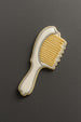 Hairbrush-shaped cookie on a dark gray background from a 4 inch Hair Brush Metal Cookie Cutter