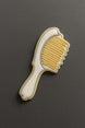 Hairbrush-shaped cookie on a dark gray background from a 4 inch Hair Brush Metal Cookie Cutter