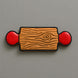 Wooden-patterned rolling pin with red circular ends on a gray background from a 5 inch Rolling Pin Metal Cookie Cutter