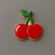 Cookie shaped like a cherry on a gray background from a 3.5 inch Cherries Metal Cookie Cutter