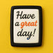 Cookie with 'Have a great day!' text on a yellow background from a 2.5 inch X 1.43 inch Rectangle Biscuit Metal Cookie Cutter