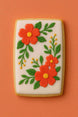 Decorative cookie with orange flowers and green leaves on a white background from a 3.5 inch X 2.0625 inch Rectangle Biscuit Metal Cookie Cutter