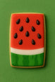 Decorative cookie shaped like a watermelon on a green background from a 4.5 Inch x 2.6875 Inch Rectangle Biscuit Metal Cookie Cutter