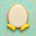 Easter-themed cookie with yellow base and white top on a patterned background from a 3.25 inch Egg with Feet Humpty Dumpty Metal Cookie Cutter