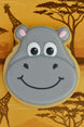 Hippo-shaped cookie with a cartoon face on a background with giraffes and trees FROM A 4.5 inch Hippopotamus Face Metal Cookie Cutter