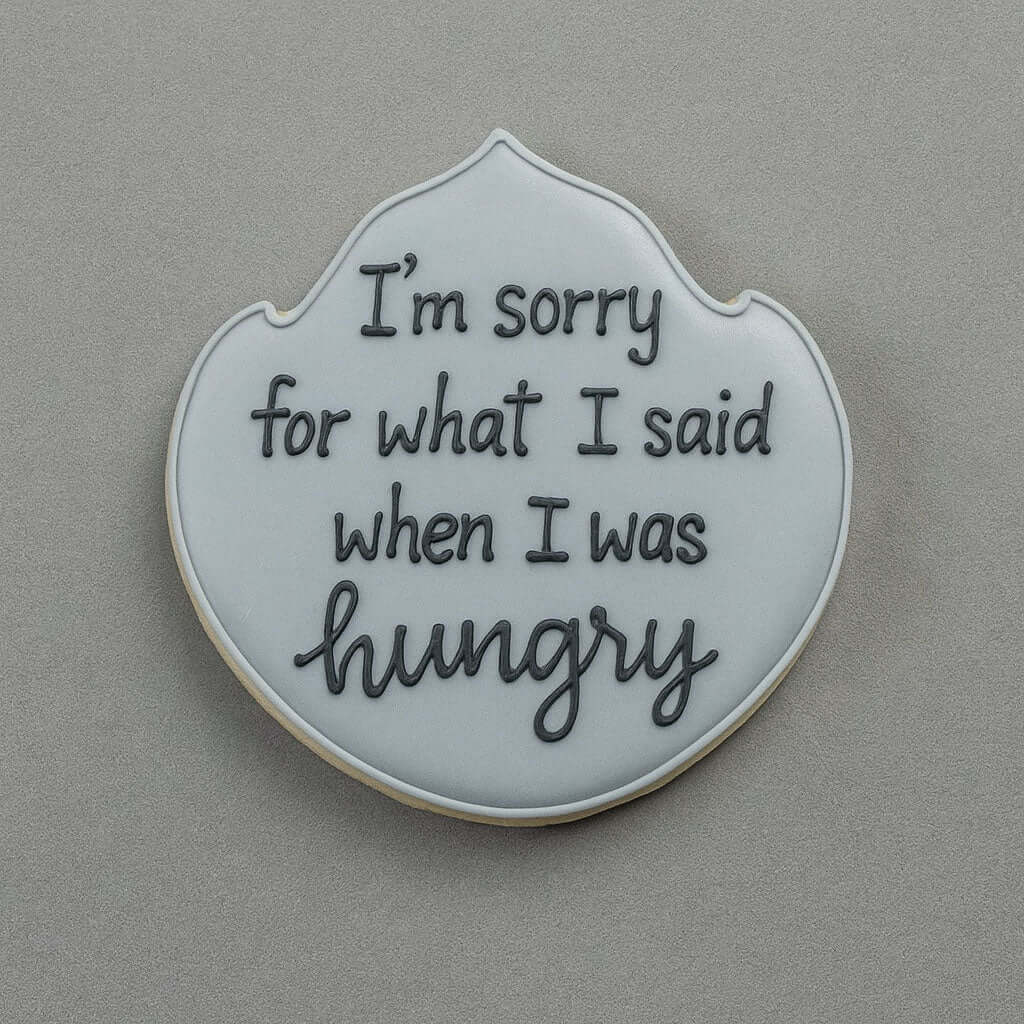 Cookie with text 'I'm sorry for what I said when I was hungry' on a gray background from a 4.75 inch Plaque or Frame Metal Cookie Cutter