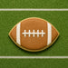 Football-shaped cookie on a green field background from a 5.5 inch Eye or Football Metal Cookie Cutter