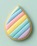 Teardrop-shaped cookie with pastel color stripes on a light green background from a 2.5 inch Tear Drop Rain Flower Petal Metal Cookie Cutter