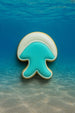 Jellyfish-shaped cookie on a blue underwater background from a 3.5 inch Jellyfish Metal Cookie Cutter