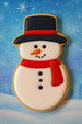 Snowman cookie with a blue snowy background from a 4.5 inch Snowman Metal Cookie Cutter