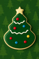 Christmas tree-shaped cookie with colorful candies on a green background from a 4 inch Tree with Star Metal Cookie Cutter