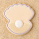 Clam shell with pearl  outlined in purple cookie on a sandy background from a 4 inch Oyster Clam Shell Metal Cookie Cutter