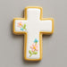 Decorative cross-shaped cookie with floral designs on a gray background from a 1.75 inch Mini Cross Metal Cookie Cutter