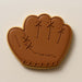 Brown leather baseball glove cookie on a beige background from a 1.75 inch Mini Baseball Glove Metal Cookie Cutter