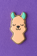 Cookie-shaped pin with a llama design on a purple background from a 2.25 inch Mini Llama Head Metal Cookie Cutter