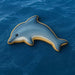 Dolphin-shaped cookie on a blue ocean background from a 2 inch Mini Dolphin Metal Cookie Cutter