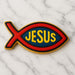 Decorative cookie shaped like a fish with 'JESUS' text on a marble background from a 2 inch Mini Jesus Fish Christian Symbol Metal Cookie Cutter
