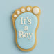 Decorative cookie shaped like a baby footprint with 'It's a Boy' text on a light blue background from a 2 inch Mini Left Foot Metal Cookie Cutter
