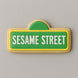 Cookie shaped like a Sesame Street sign with green background and white text on a gray background from a 2.25 inch Mini Street Sign Metal Cookie Cutter