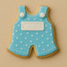 Cookie shaped like a blue polka dot romper with white buttons on a beige background from a 2 inch Mini Baby Overalls Metal Cookie Cutter