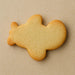 Plain airplane-shaped cookie on a beige backgroundfrom a 4 inch Airplane Metal Cookie Cutter