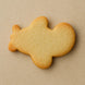 Plain airplane-shaped cookie on a beige backgroundfrom a 4 inch Airplane Metal Cookie Cutter