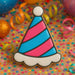 Colorful party hat cookie on a festive background with confetti and ribbons for a 3.5 inch Party Hat Metal Cookie Cutter
