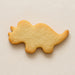 Plain triceratops-shaped cookie on a beige background from a 4 inch Triceratops Metal Cookie Cutter