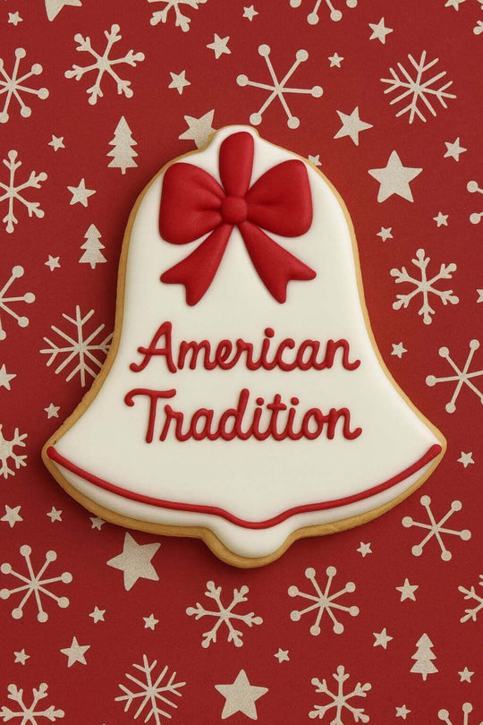 Decorative cookie shaped like a bell with a red bow and 'American Tradition' text on a red background with snowflakes from a 3.5 inch Bell Metal Cookie Cutter