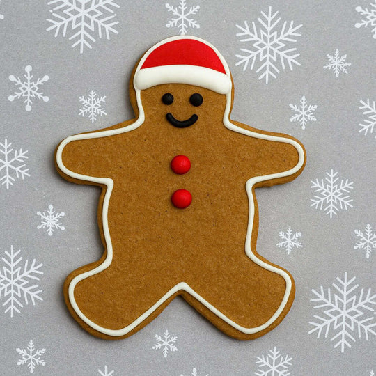 Gingerbread man cookie with a red hat and buttons on a gray background with snowflakes from a 5 inch Gingerbread Boy Metal Cookie Cutter