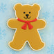 Decorative bear cookie with a red bow on a blue background with snowflakes from a 4 inch Teddy Bear Metal Cookie Cutter 