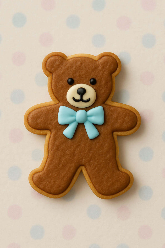 Brown teddy bear cookie with a blue bow tie on a polka dot background from a 4 inch Teddy Bear Metal Cookie Cutter