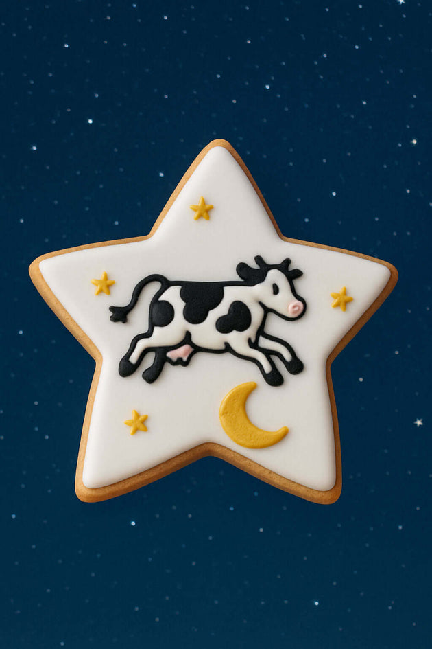 3 inch Star Metal Cookie Cutter creating a star-shaped cookie with a cow design on a blue background.